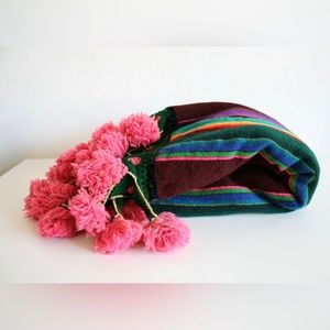 Vintage colorful striped blanket with pink poms wool